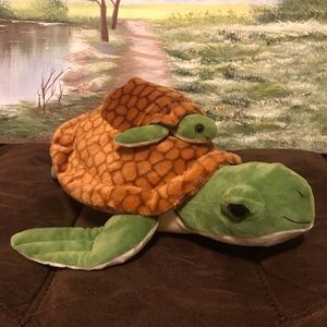 Mama turtle with baby turtle in back pouch